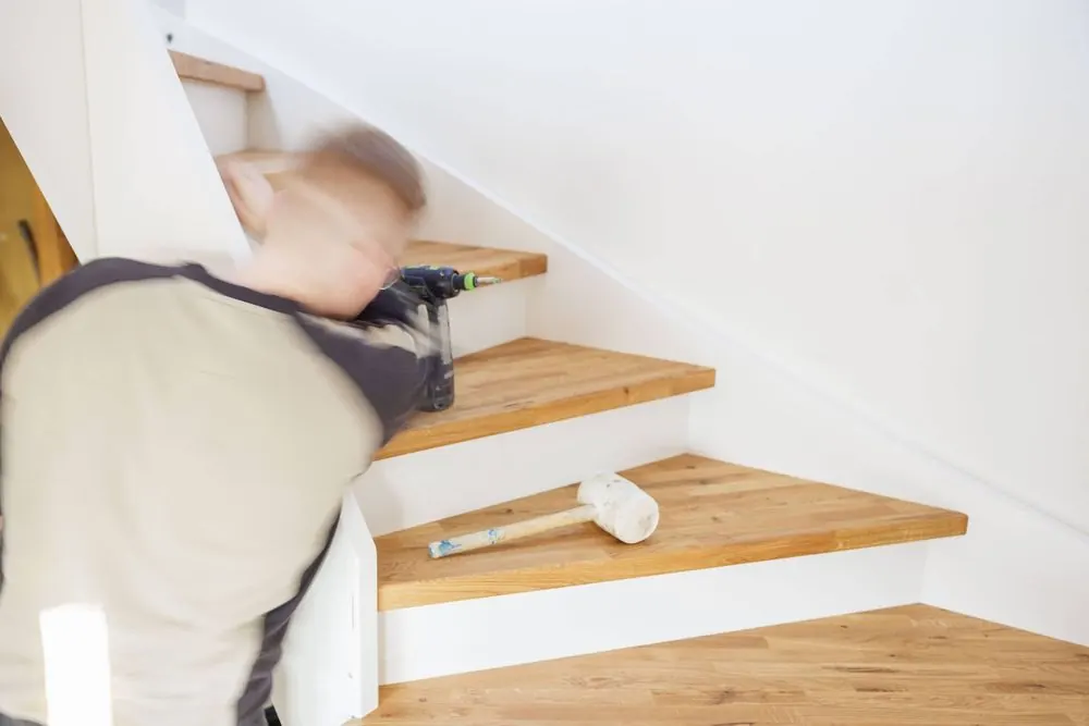 Staircase Construction 3 – Craft photography: installation of a wooden staircase in motion.