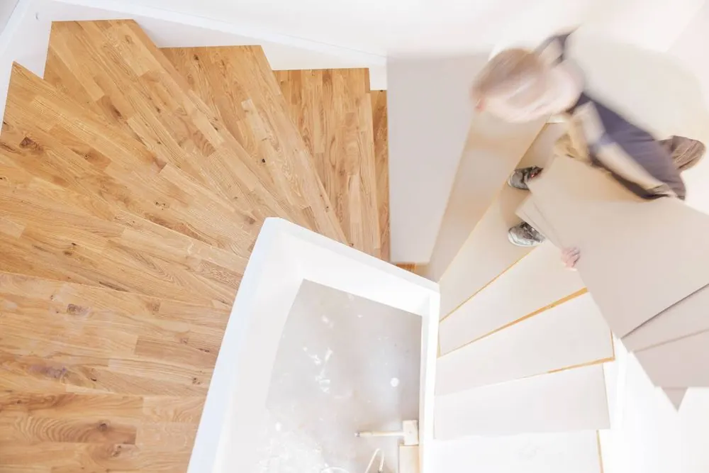 Staircase Construction 4 – Craft photography: installation of a wooden staircase in motion.