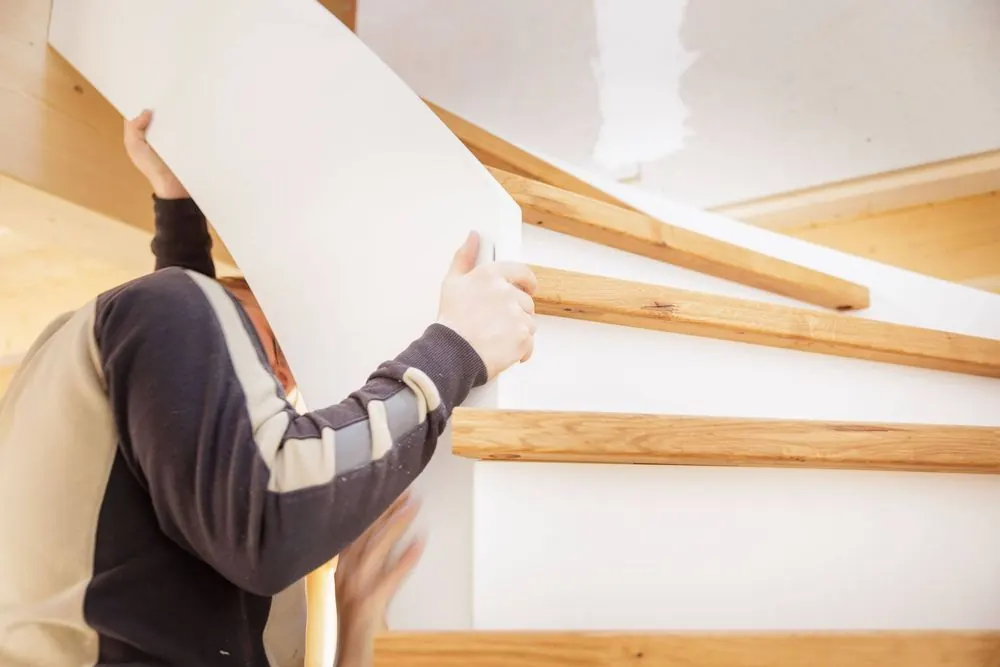 Staircase Construction 5 – Craft photography: installation of a wooden staircase in motion.